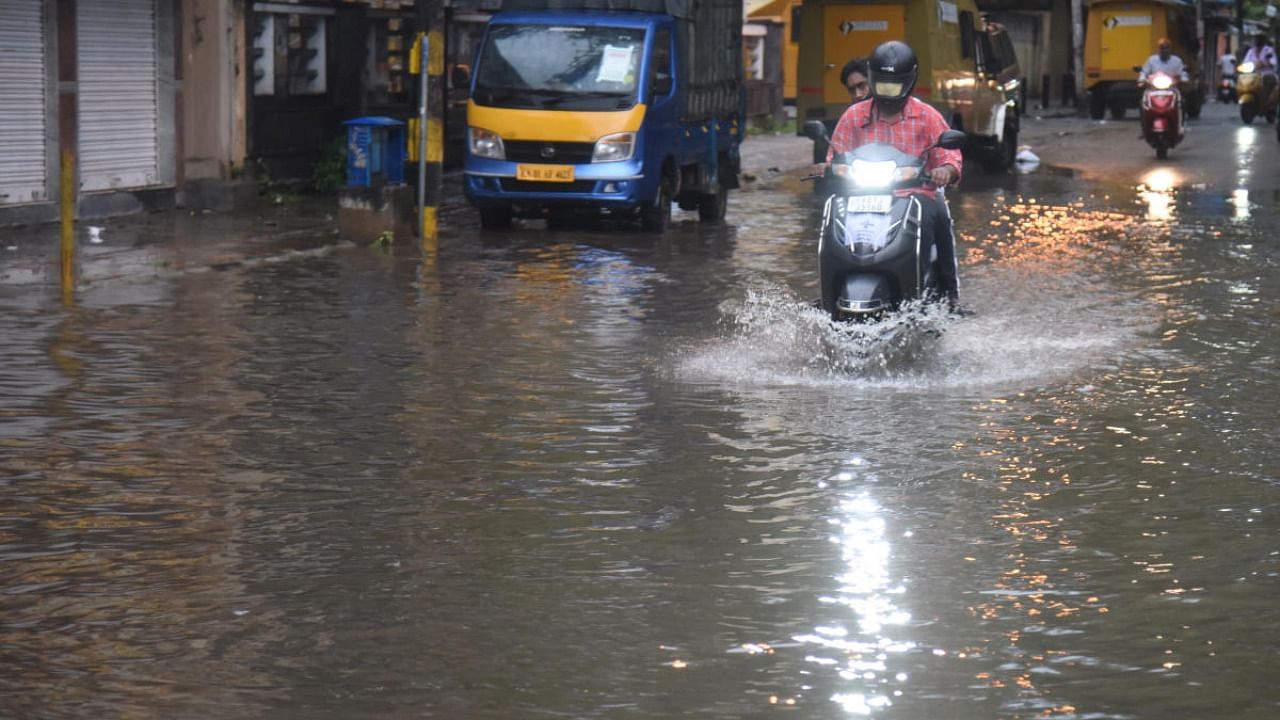 Motorist struggle to drive in Rain and rainwater at BTS road in Bengaluru on Friday, June 4, 2021. Credit: S K Dinesh