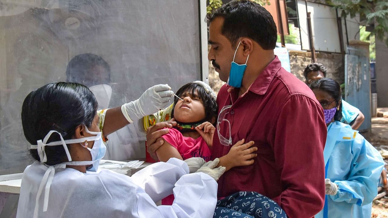 A health worker collects swab sample of a child for Covid-19 test, at Urban Health Centre in Musharabad, Friday, June 4, 2021. Credit: PTI Photo