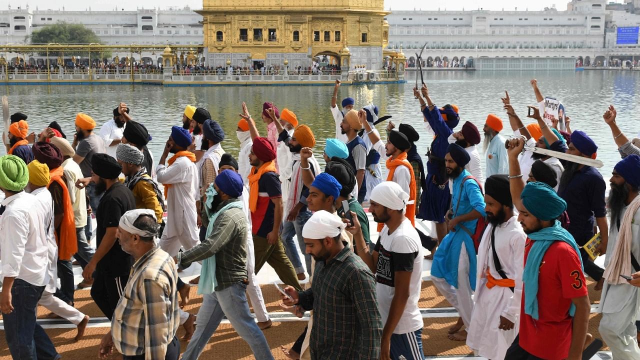 Activists of Sikh organisations hold swords as they shout pro-Khalistan slogans after offering prayers on the occasion of the 37th anniversary of Operation Blue Star, at the Golden Temple in Amritsar. Credit: AFP Photo
