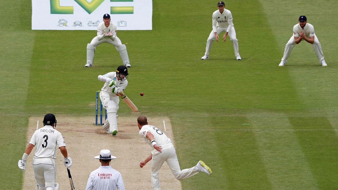 England's Stuart Broad (3R) bowls to New Zealand's Tom Latham (4R) on the fifth day of the first Test. Credit: AFP Photo