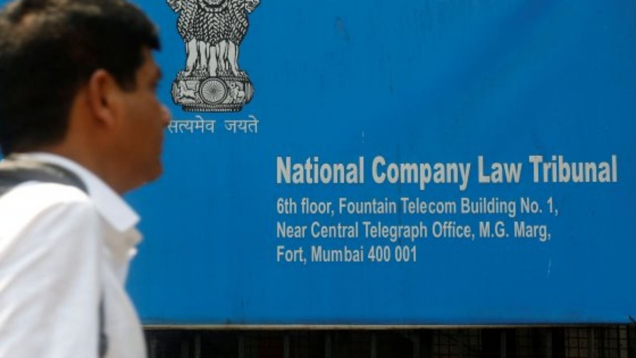 A man walks past a signboard of the National Company Law Tribunal (NCLT) outside it's office in Mumbai. Credit: Reuters Photo