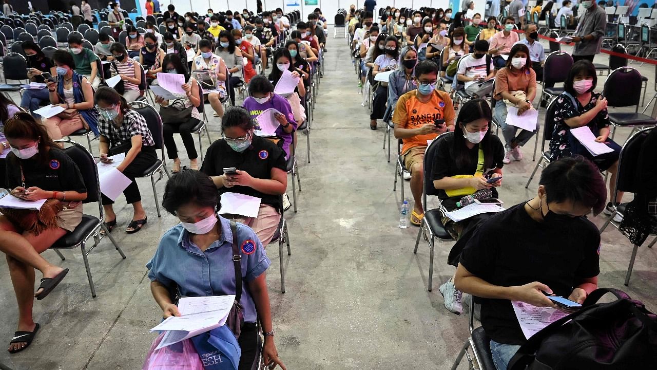 People wait for a period to monitor for side effects after being administered a dose of the AstraZeneca Covid-19 coronavirus vaccine inside the Central World shopping mall in Bangkok on June 7, 2021, as mass vaccine rollouts begin in Thailand. Credit: AFP Photo
