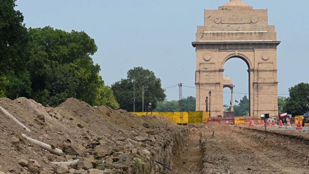 The site of a redevelopment work of the Central Vista Avenue by Central Public Works Department (CPWD) along the Rajpath road is pictured in front of the India Gate in New Delhi on May 9, 2021. Credit: AFP Photo