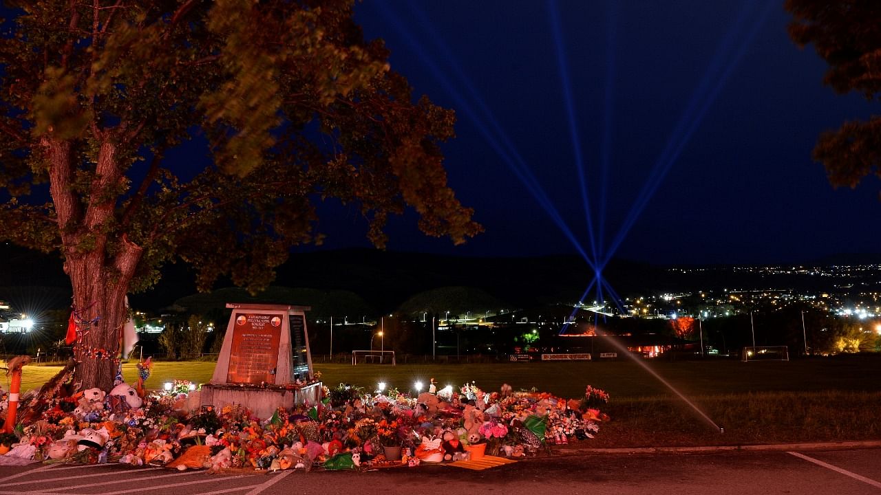 Lights rise from the pow wow grounds near the former Kamloops Indian Residential School after the remains of 215 children, some as young as three years old, were found at the site in Kamloops, British Columbia, Canada. Credit: Reuters photo