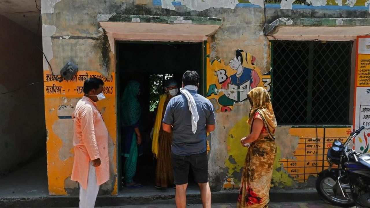 People wait to get a dose of the Covishield vaccine against Covid-19 at a health centre in Sultanpur village in Ghaziabad on June 4, 2021. Credit: AFP Photo