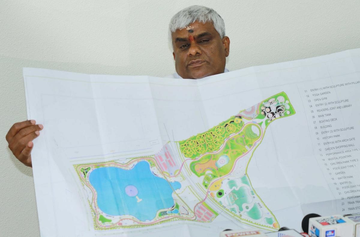 MLA H D Revanna displays the blue print of the Channapattana lake in Hassan on Wednesday. DH PHOTO