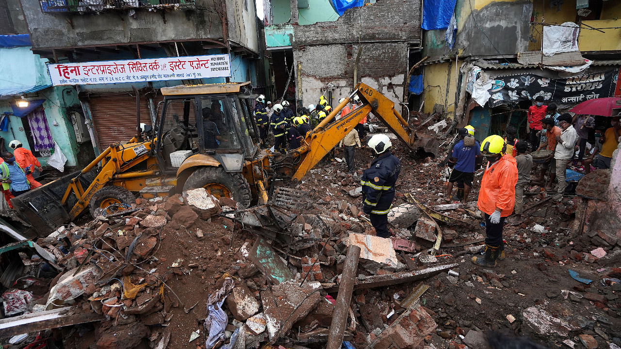Rescue workers remove debris to search for survivors after a residential building collapsed on top of another building in Mumbai. Credit: Reuters Photo