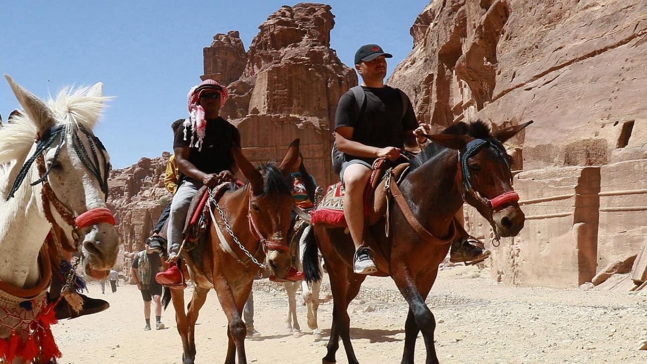 Tourists ride donkeys and horses as they visit Jordan's ancient city of Petra. Credit: AFP Photo