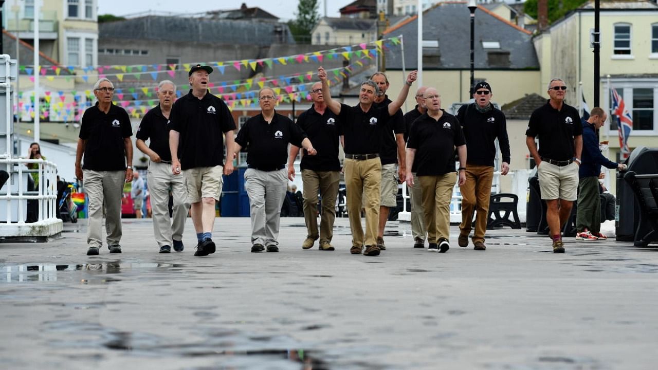 Sea Shanty singing group Bryher's Boys pose for a picture at Prince Wales Pier in Falmouth. Credit: Reuters Photo 
