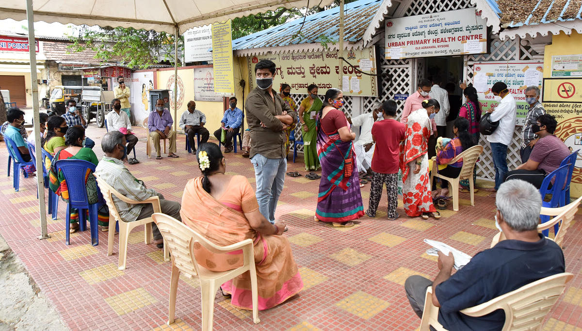 People wait for their turn to get the vaccine at an urban primary centre in Mysuru recently. Credit: DH File Photo
