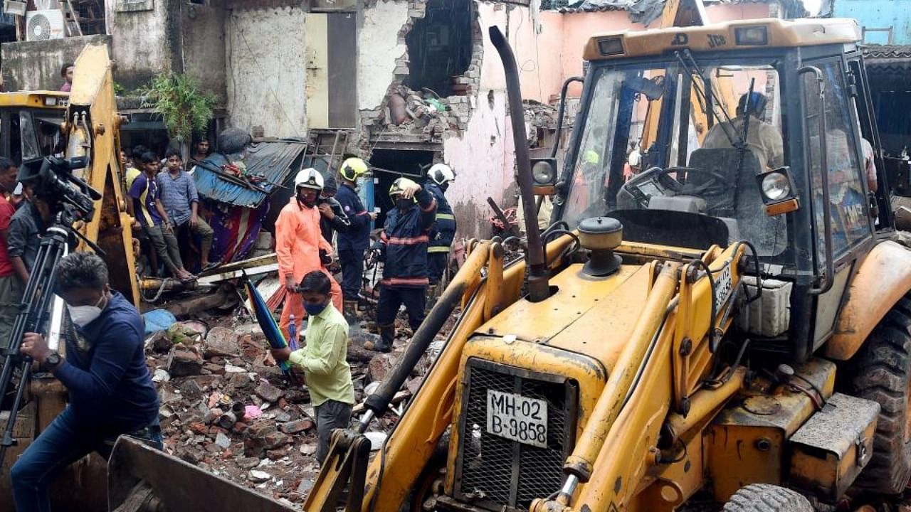 Rescue operation underway after a single-storey house collapsed on another structure in Malwani area on Wednesday night, in Mumbai, Thursday, June 10, 2021. Credit: PTI Photo