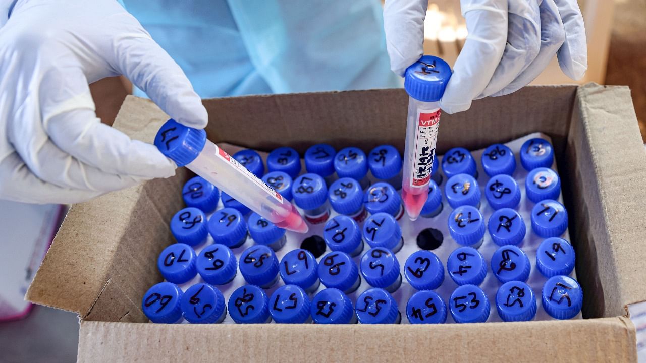 A health worker arranges Covid-19 test samples. Credit: PTI Photo