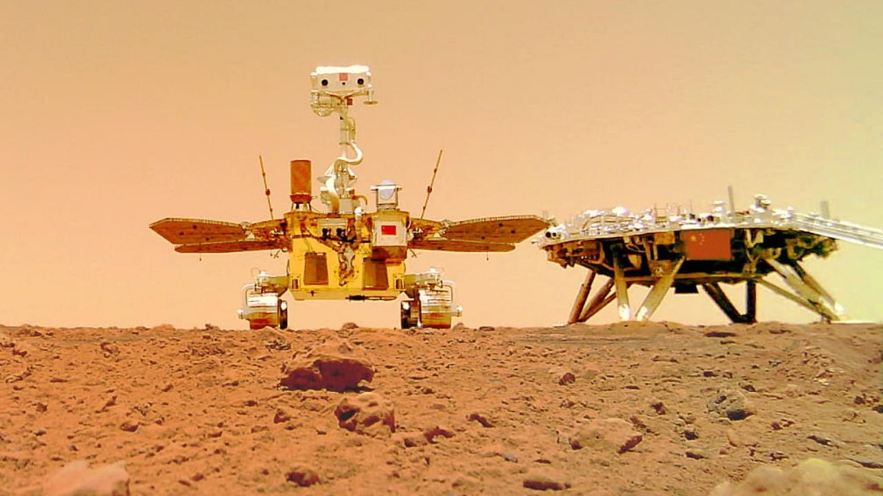 Chinese rover Zhurong and the lander of the Tianwen-1 mission, captured on the surface of Mars by a camera detached from the rover, are seen in this image released by China National Space Administration. Credit: Reuters Photo 