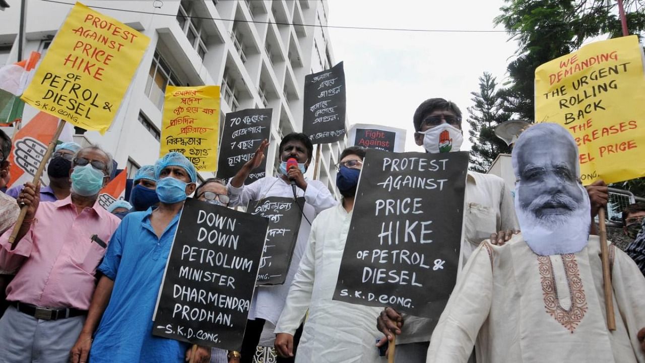 Congress activists stage a 'symbolic' protest against frequent hikes in the prices of petrol and diesel, in front of Indian Oil eastern headquarters in Kolkata. Credit: PTI Photo