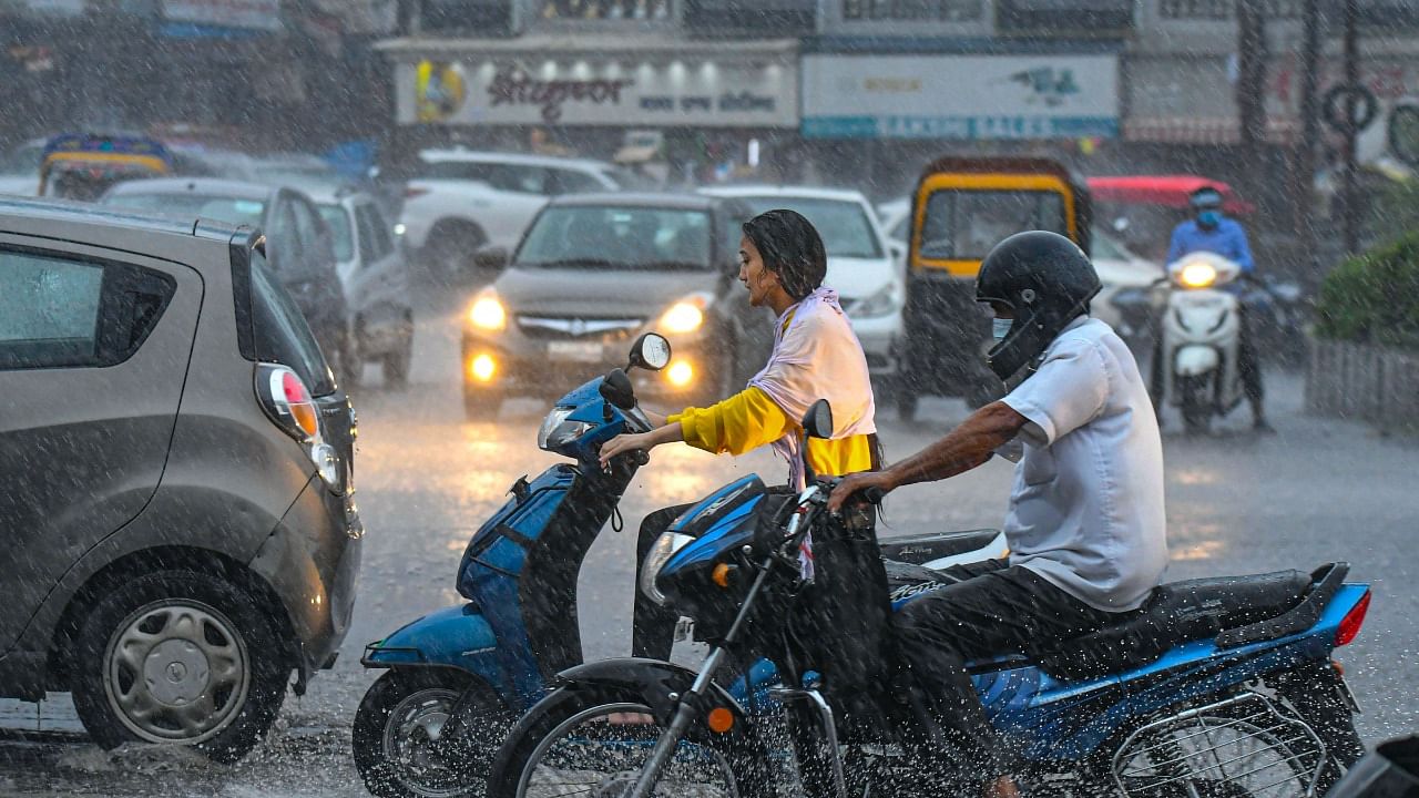 Commuters during pre-monsoon rain in Bhopal. Credit: PTI Photo