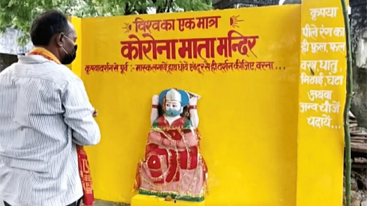 A devotee cheers while standing near an idol of 'Corona Mata' (Mother Corona), at a temple in Pratapgarh, Uttar Pradesh. Credit: Reuters Photo. 