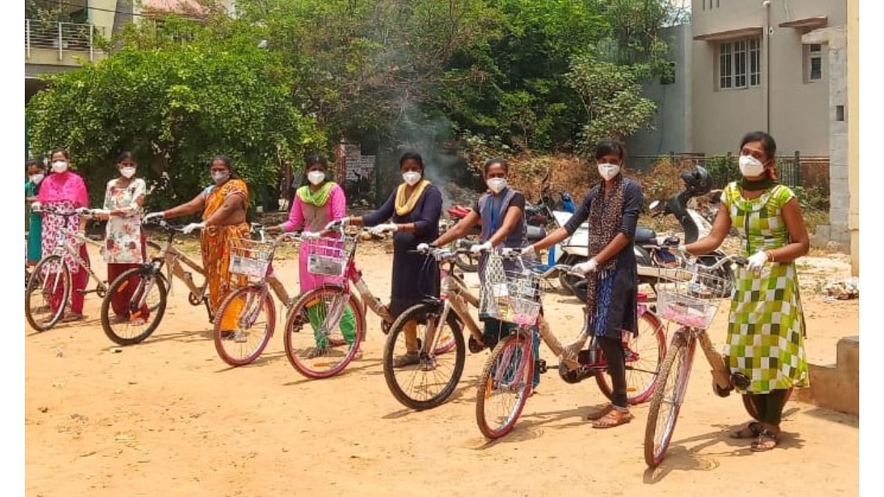 Garment workers ready to hop on to their new bicycles.