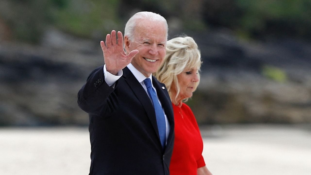 US President Joe Biden waves as he walks with first lady Jill Biden (R) along the boardwalk during the G7 summit in Carbis Bay, Cornwall. Credit: AFP Photo