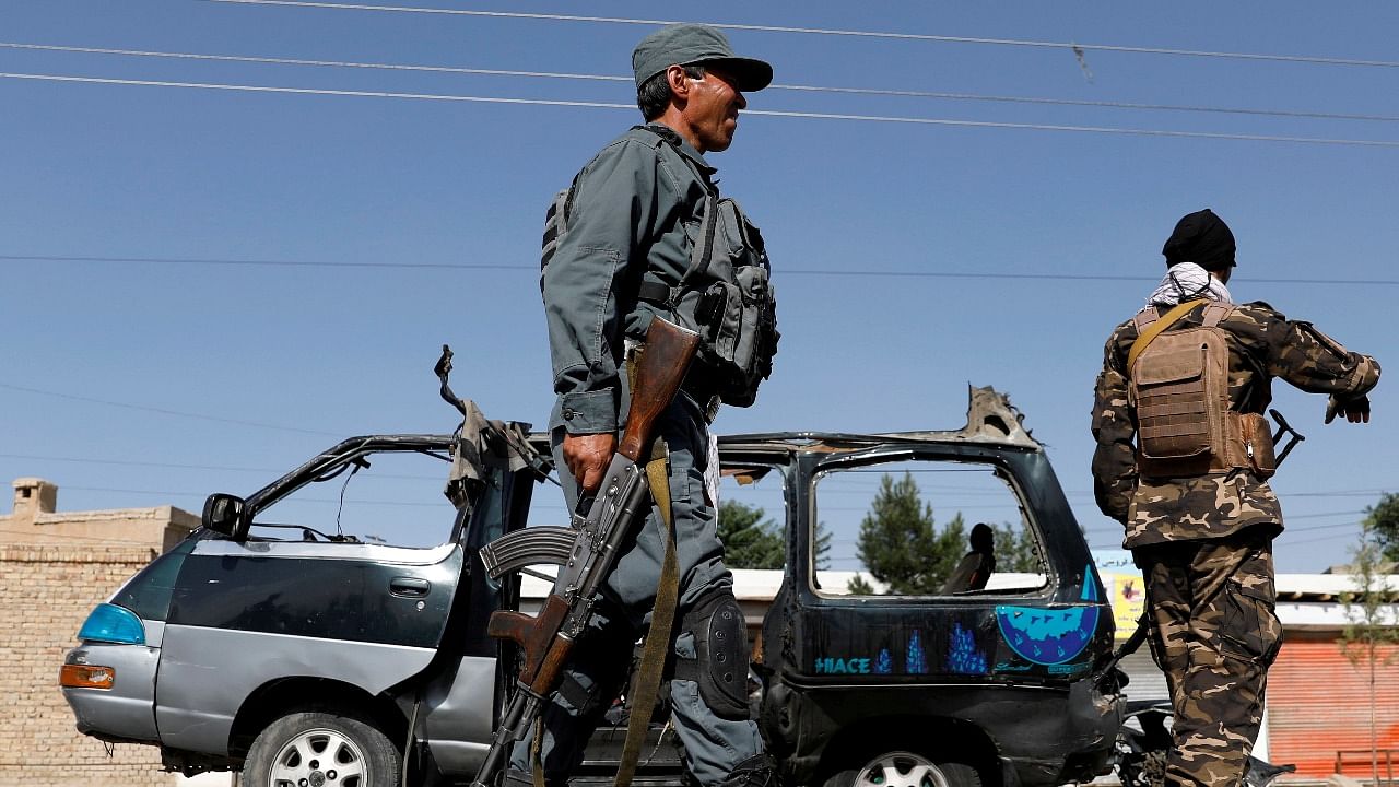 Afghan police officer inspects a damaged van after a blast in Kabul. Credit: Reuters file photo
