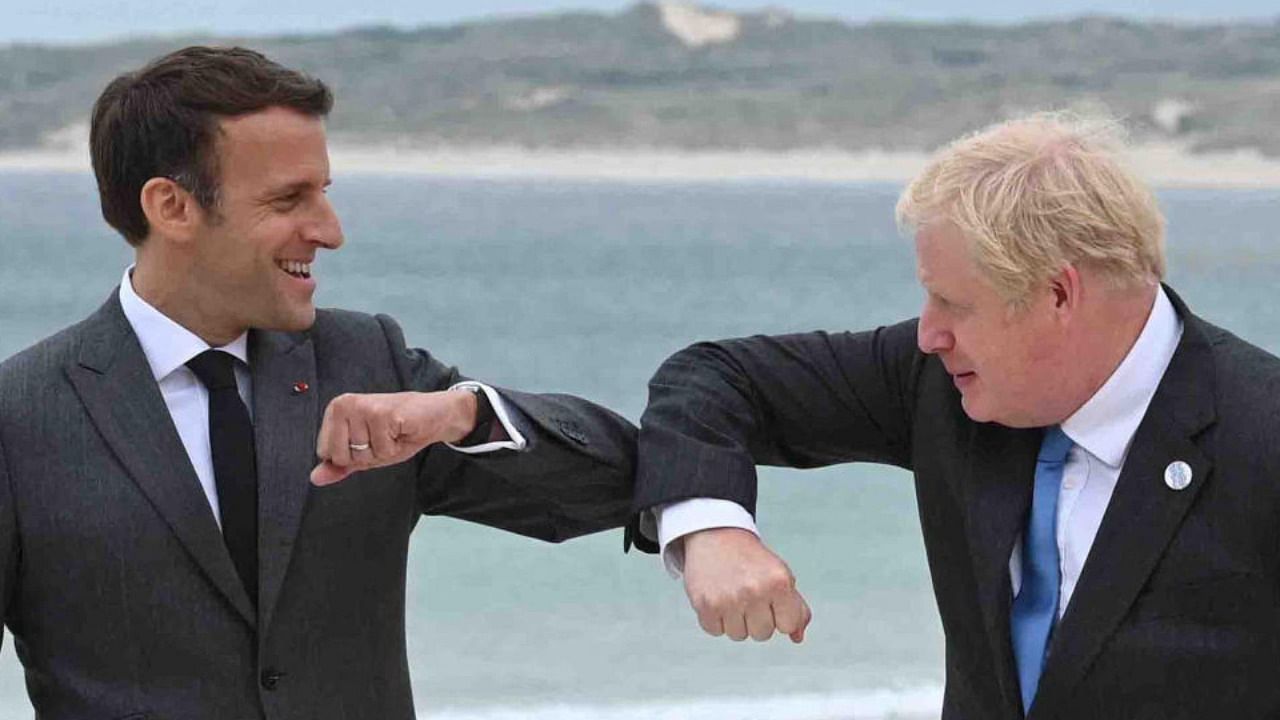 Britain's Prime Minister Boris Johnson (R) greets France's President Emmanuel Macron (L) at the start of the G7 summit in Carbis Bay, Cornwall on June 11, 2021. Credit AFP Photo