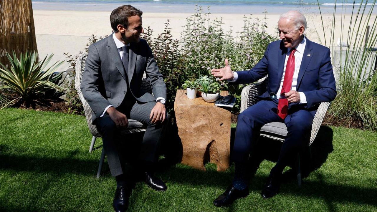 France's President Emmanuel Macron greets US President Joe Biden before a bilateral meeting during the G7 summit in Carbis bay, Cornwall. Credit: AFP Photo