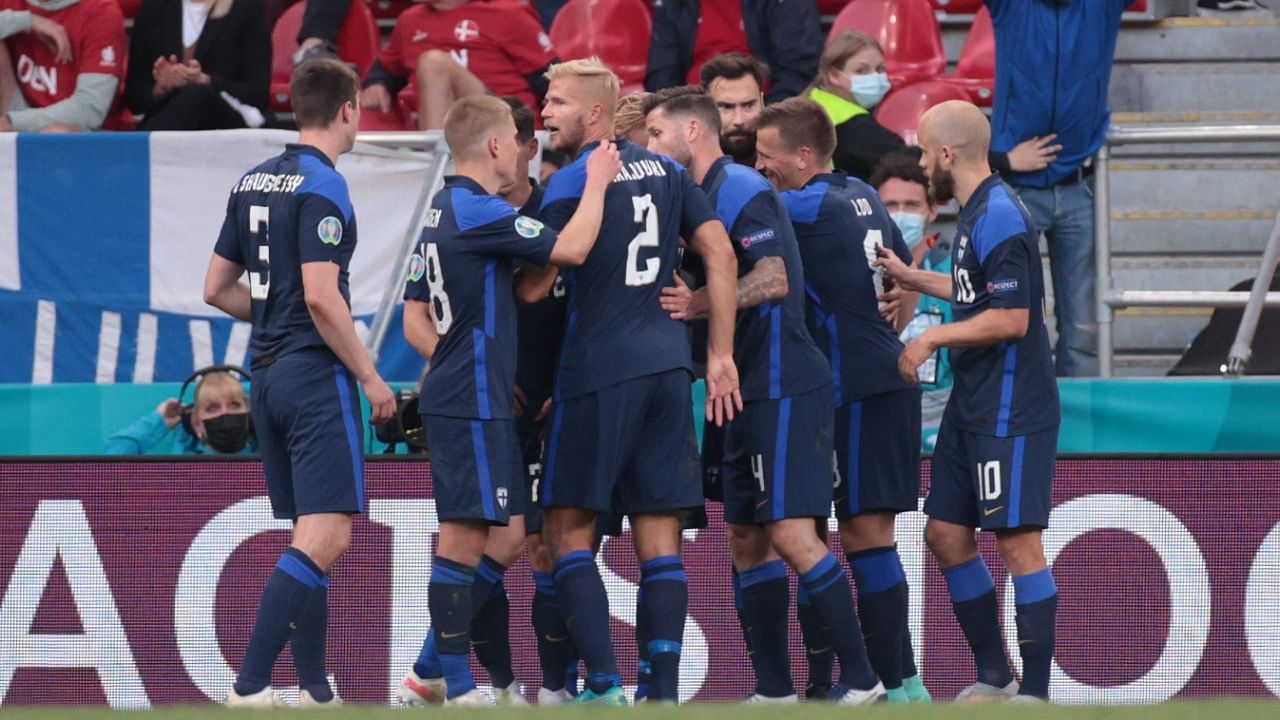 Finland's players celebrate their opening goal scored by forward Joel Pohjanpalo in their 1-0 win over Denmark in Euro 2020. Credit: AFP Photo