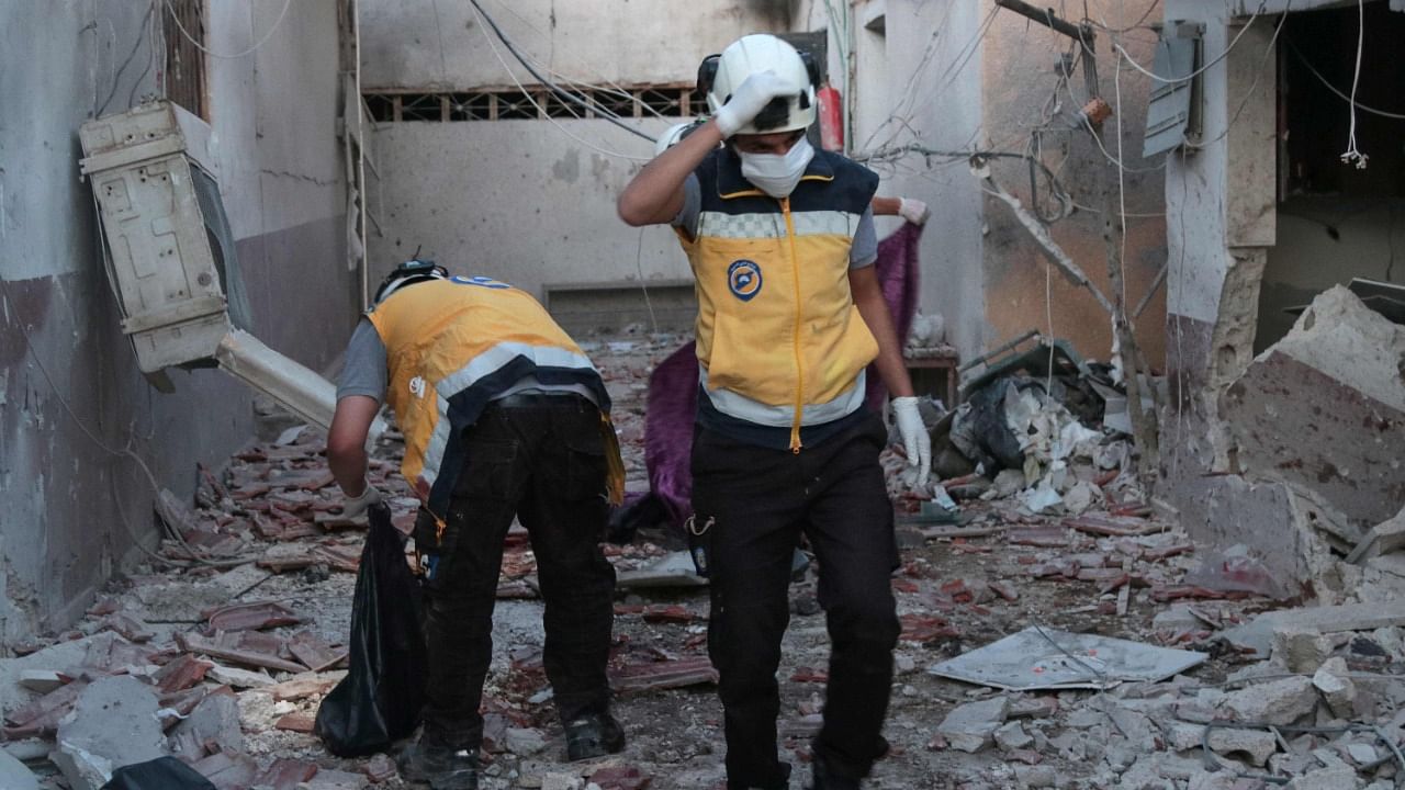 Members of Syria's Civil Defence service (White Helmets) sift through the rubble at Al-Shifaa hospital following shelling of the rebel-held city of Afrin in northern Syria. Credit: AFP Photo