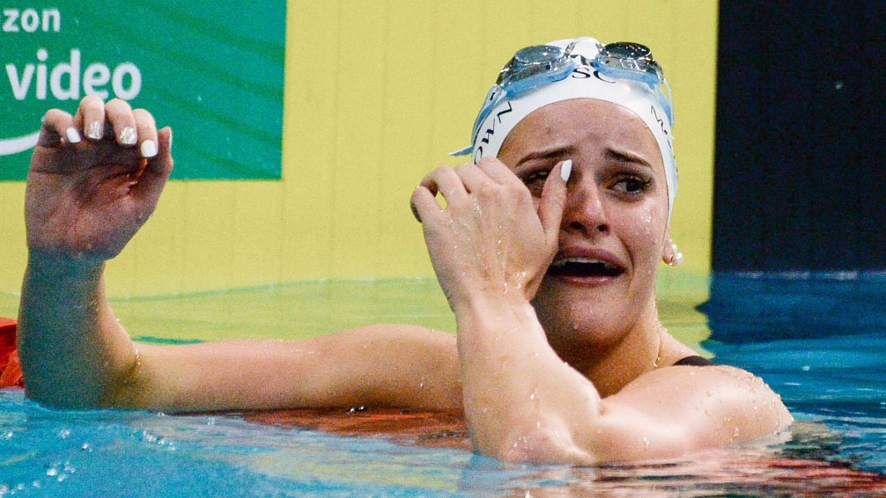 Kaylee McKeown reacts after setting a new world record time in the women's 100m backstroke final during day two of the Australian Olympic swimming trials in Adelaide on June 13, 2021. Credit: AFP Photo