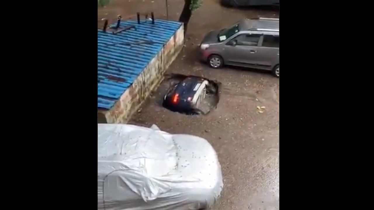 A car sank in a caved in ground in Mumbai. Credit: Video screengrab