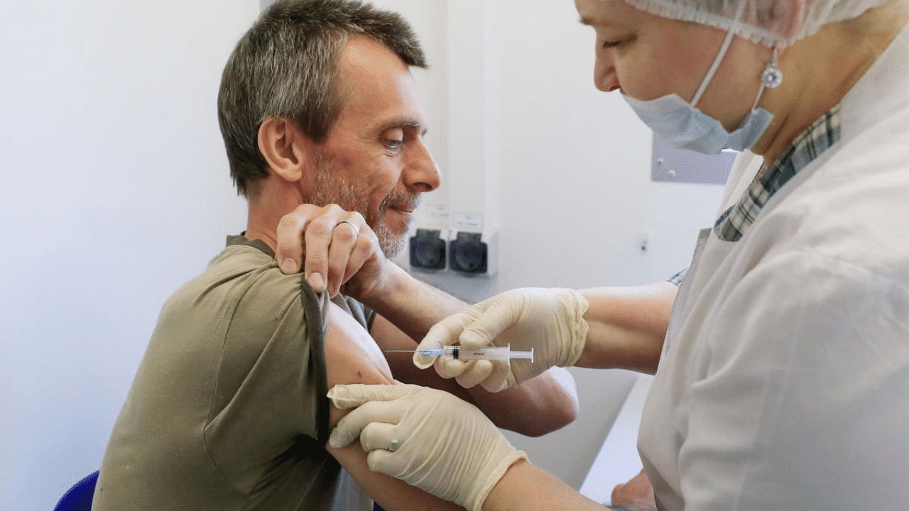 A man receives a dose of Sputnik V (Gam-COVID-Vac) vaccine against the coronavirus disease at a mobile vaccination centre in a dacha community near the village of Poyarkovo in the Moscow Region. Credit: Reuters Photo