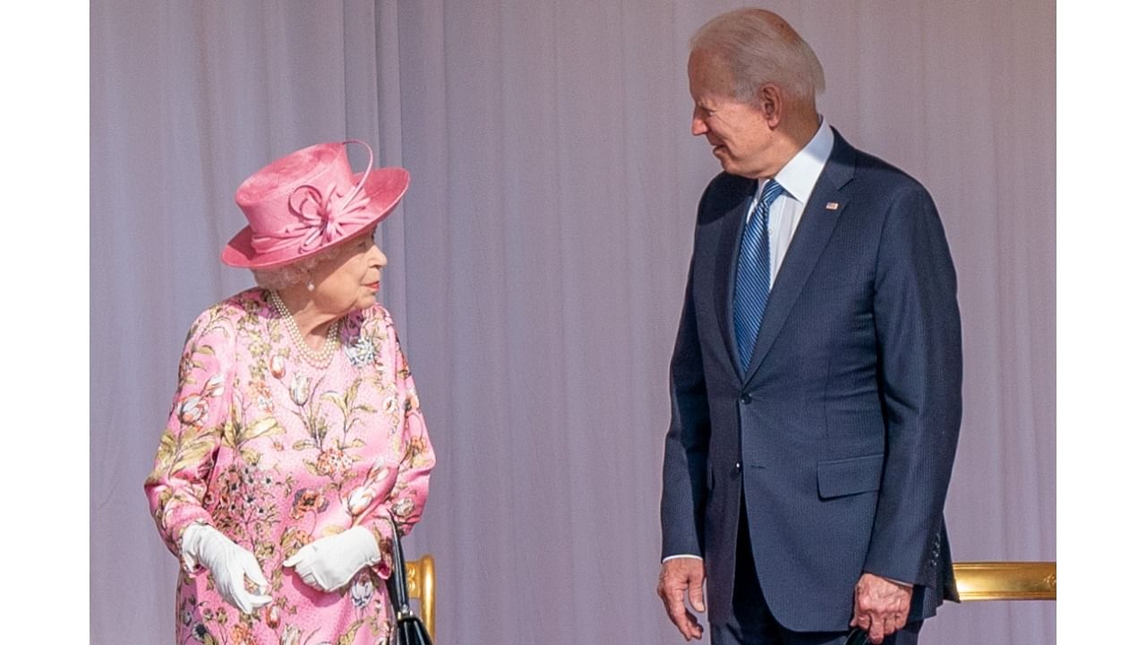 US President Joe Biden stands next to Britain's Queen Elizabeth as they meet at Windsor Castle, in Windsor, Britain. Credit: Reuters Photo