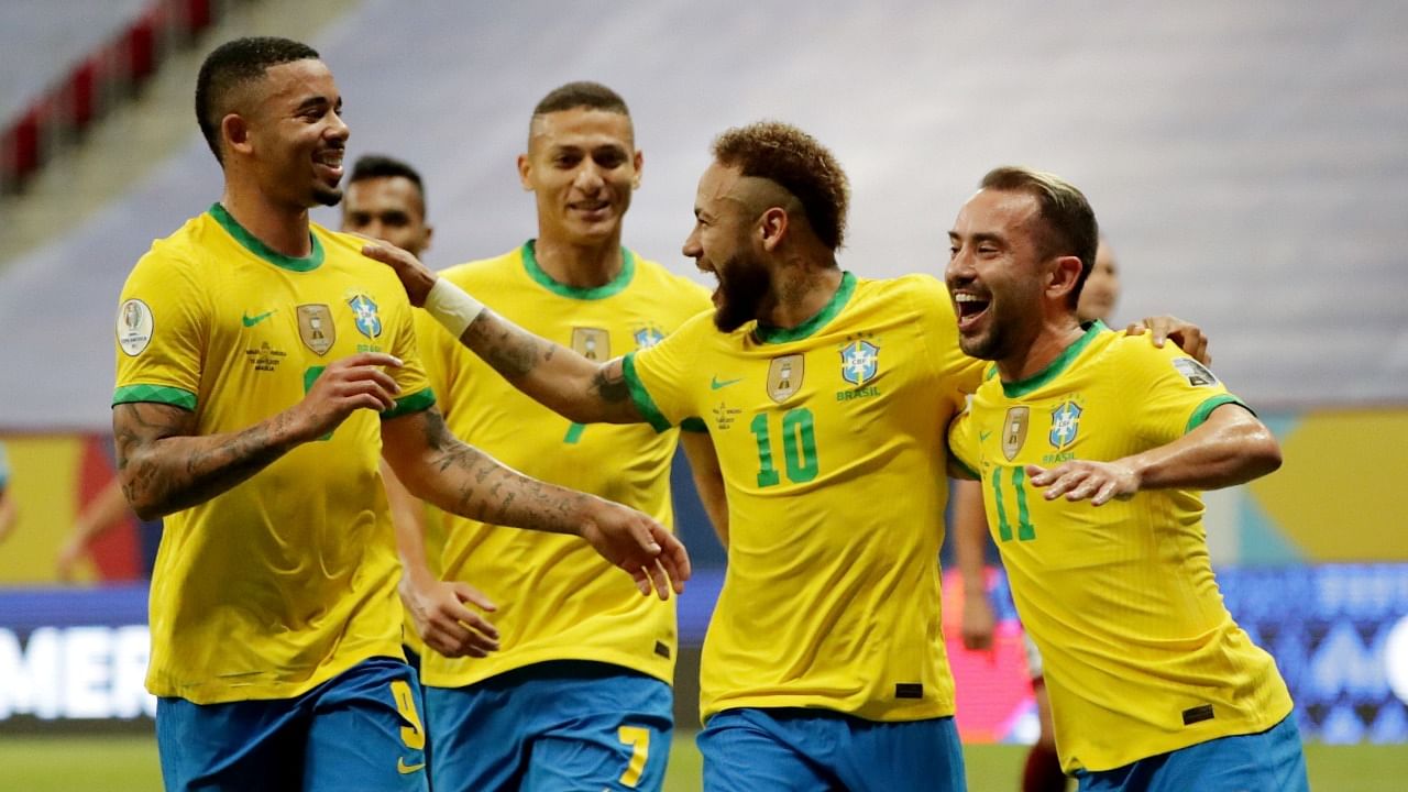 Brazil's Neymar celebrates scoring their second goal with teammates in a 3-0 win over Venezuela. Credit: Reuters Photo