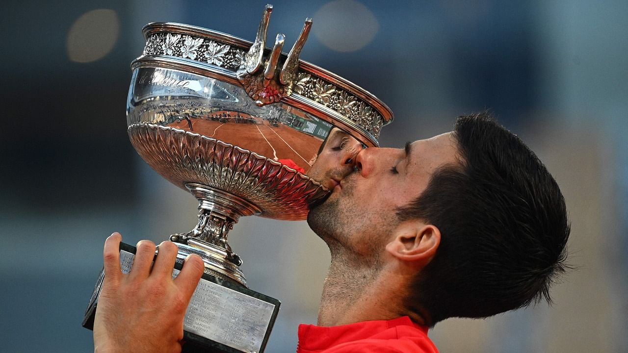 Serbia's Novak Djokovic kisses The Mousquetaires Cup (The Musketeers) after defeating Greece's Stefanos Tsitsipas in the French Open men's singles final. Credit: AFP Photo