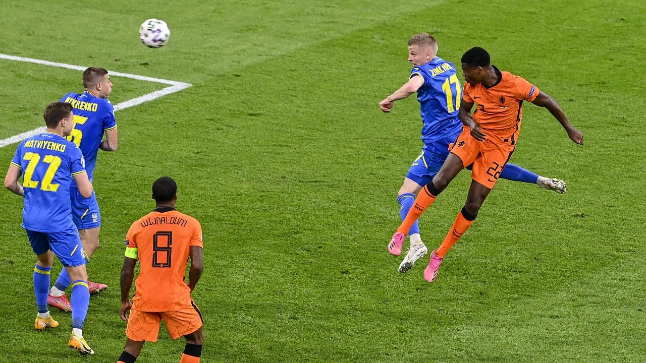 Netherlands' defender Denzel Dumfries (R) heads the ball to score the winning goal against Ukraine in their Euro 2020 clash. Credit: AFP Photo