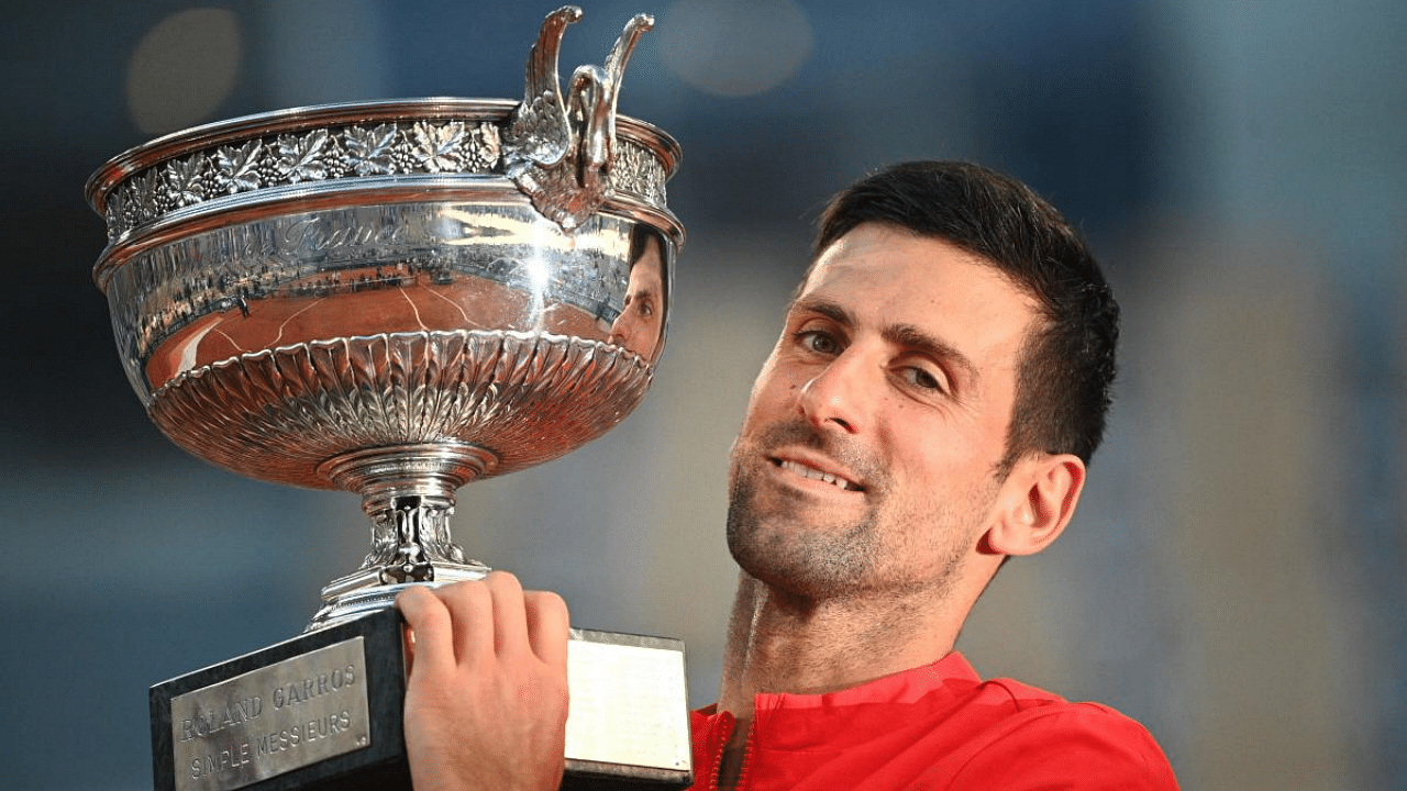 Serbia's Novak Djokovic poses with The Mousquetaires Cup (The Musketeers) after winning against Greece's Stefanos Tsitsipas at the end of their men's final tennis match. Credit: AFP Photo