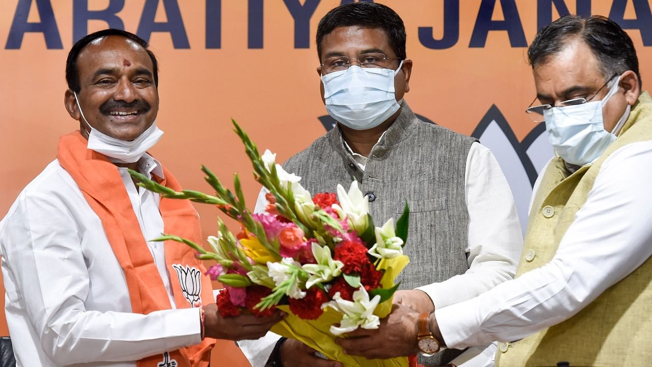 Former Telangana minister Eatala Rajender (L) being greeted by Union Minister Dharmendra Pradhan (C), as the former TRS leader joins Bharatiya Janata Party (BJP) at BJP HQ in New Delhi, Monday, June 14, 2021. Credit: PTI Photo