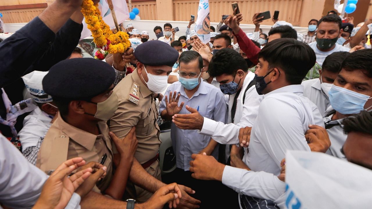 AAP party supporters welcome party chief and Delhi Chief Minister Arvind Kejriwal at new party office in Ahmedabad, Monday, June 14, 2021. Credit: PTI Photo