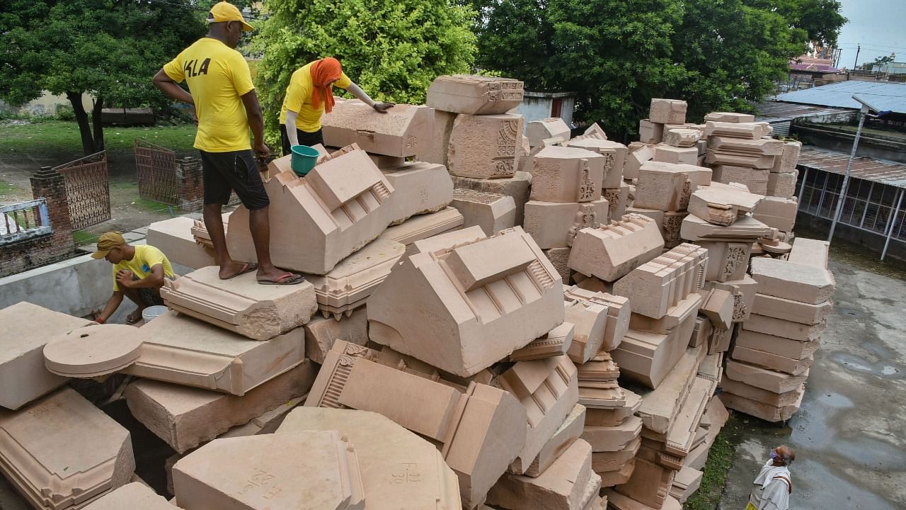 Workers clean stone blocks, to be used in construction of the Ram Temple, at a workshop in Ayodhya, Tuesday, July 21, 2020. Credit: PTI File Photo