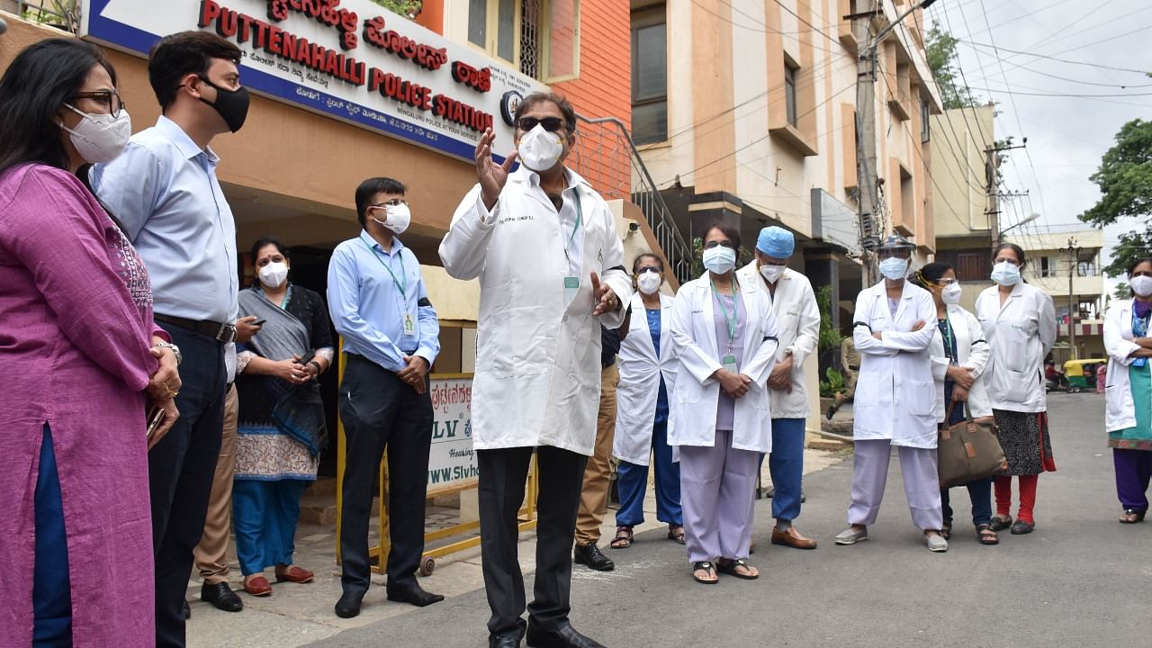 Fortis Hospital staff stand outside Puttenahalli Police Station, protesting violence against doctors. Credit: DH Photo/Janardhan B K