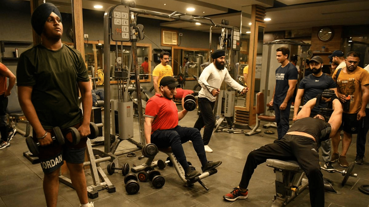 Gym-goers exercise after indoor gyms reopen as restrictions imposed against the spread of the Covid-19 are eased, in Amritsar. Credit: AFP Photo
