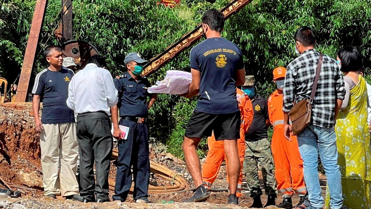 Indian Navy officers with NDRF, SDRF & firemen, during a rescue operation for miners trapped inside a 500 feet deep coal mine, in East Jaintia Hills district, Monday, June 14, 2021. Credit: PTI Photo