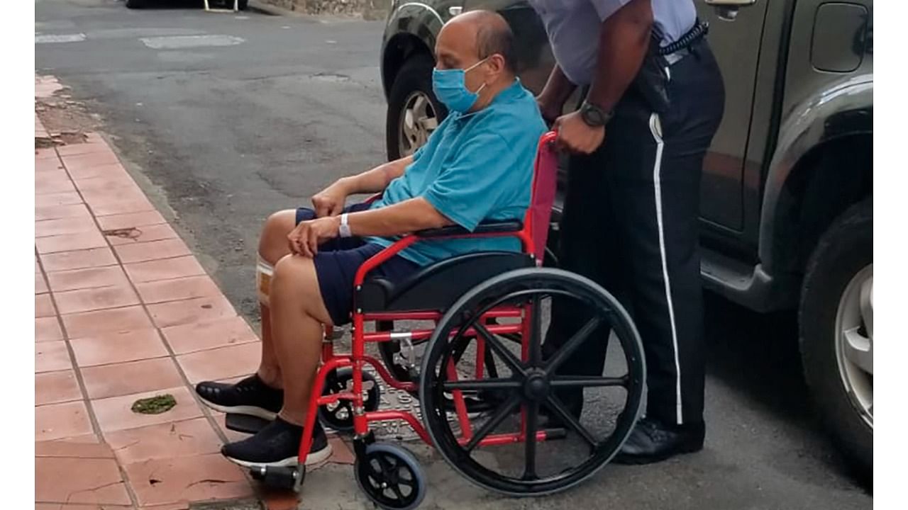 Indian citizen Mehul Choksi is taken in a wheelchair to the Magistrate's court by police after his arrest for illegal entry into the country, in Roseau, Dominica, Wednesday, June 2, 20121. Credit: AP/PTI Photo