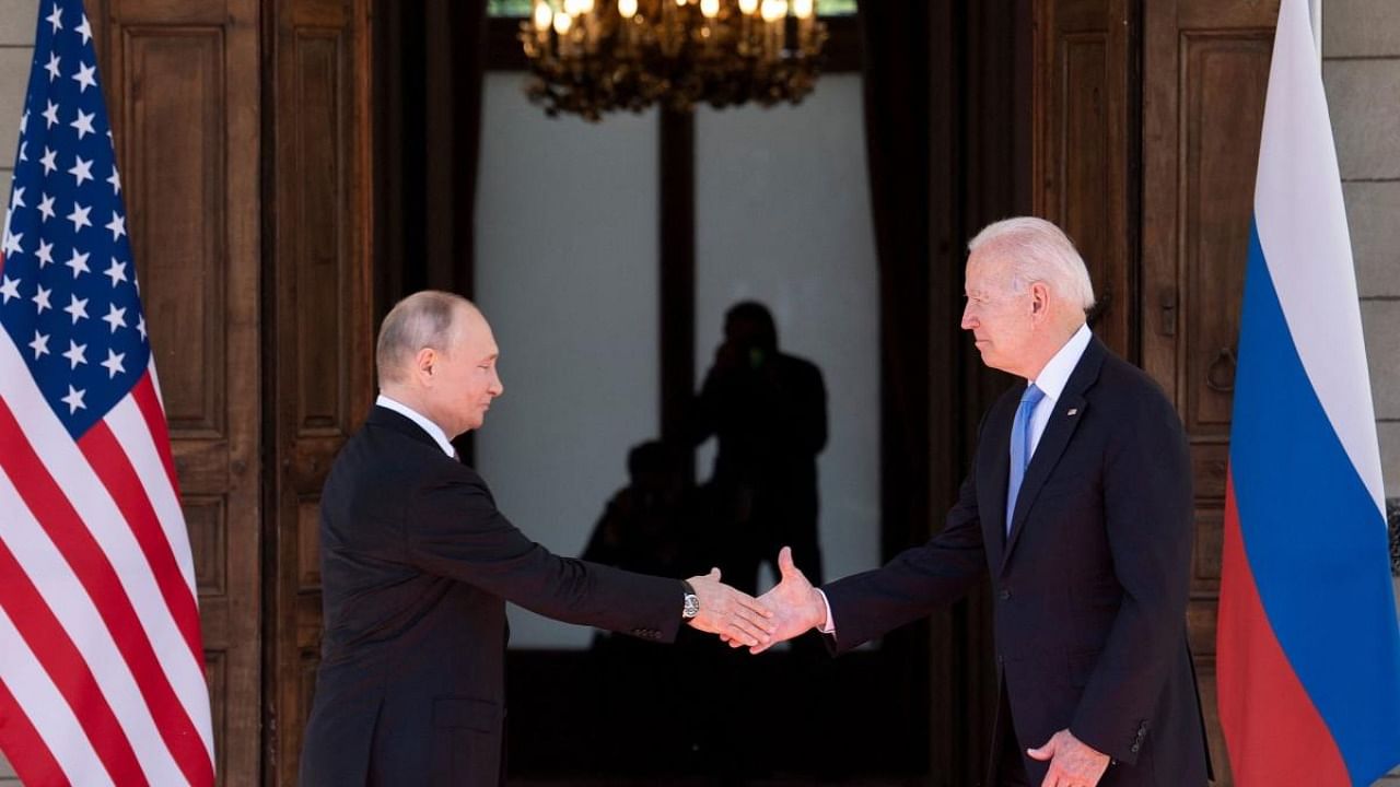 Russian President Vladimir Putin (L) shakes hands with US President Joe Biden. Credit: AFP Photo