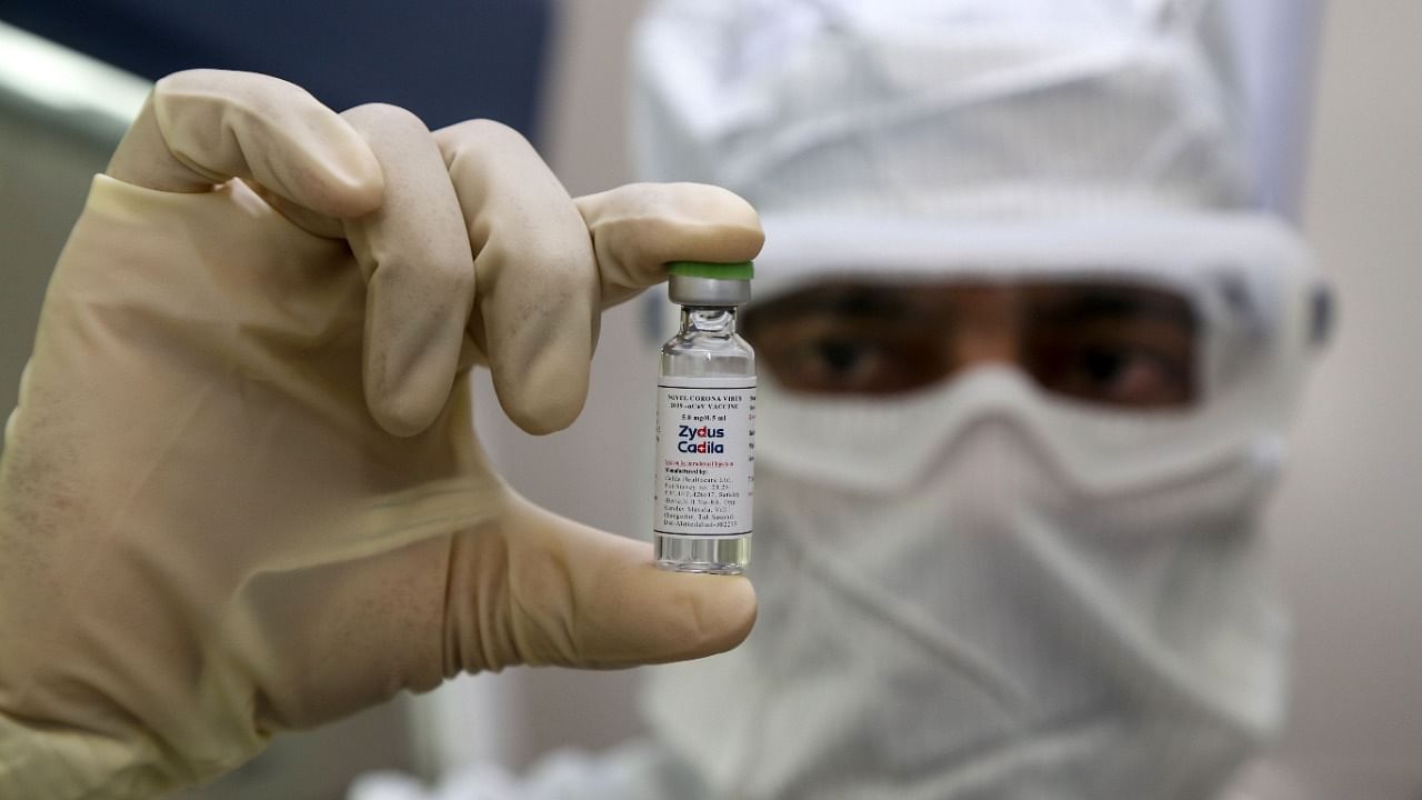 A pharmaceutics worker shows a shot of a vaccine developed by Zydus Cadila. Credit: AFP File Photo