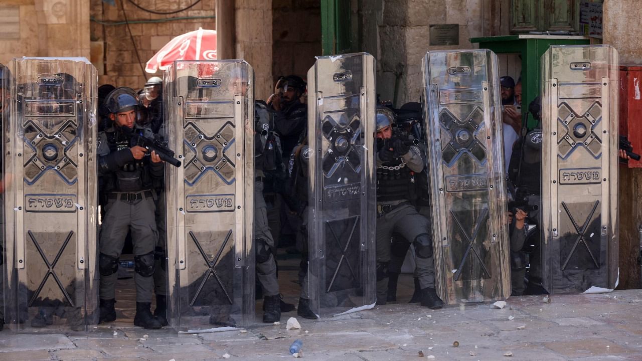 Members of the Israeli security forces stand on alert during a protest by Palestinians in response to chants by Israeli ultranationalists targeting Islam's Prophet Mohammed in the March of Flags earlier this week, following the Friday prayers at the Al-Aqsa mosque compound in Jerusalem, on June 18, 2021. Credit: AFP Photo