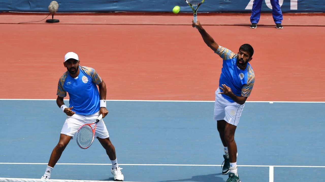 India's Rohan Bopanna (R) plays a shot next to partner Divij Sharan. Credit: AFP Photo