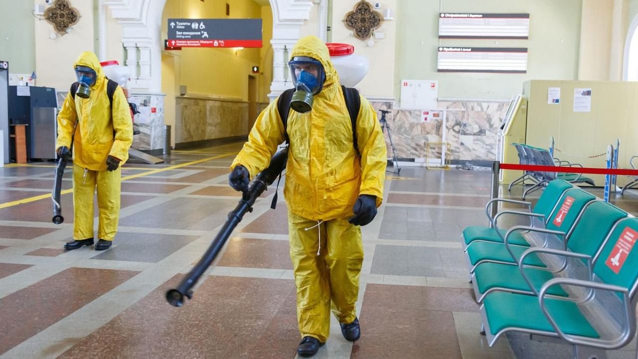 Specialists wearing personal protective equipment (PPE) spray disinfectant while sanitizing the Rizhsky Railway Station, one of the measures to curb the spread of the coronavirus disease (Covid-19), in Moscow, Russia. Credit: Reuters Photo