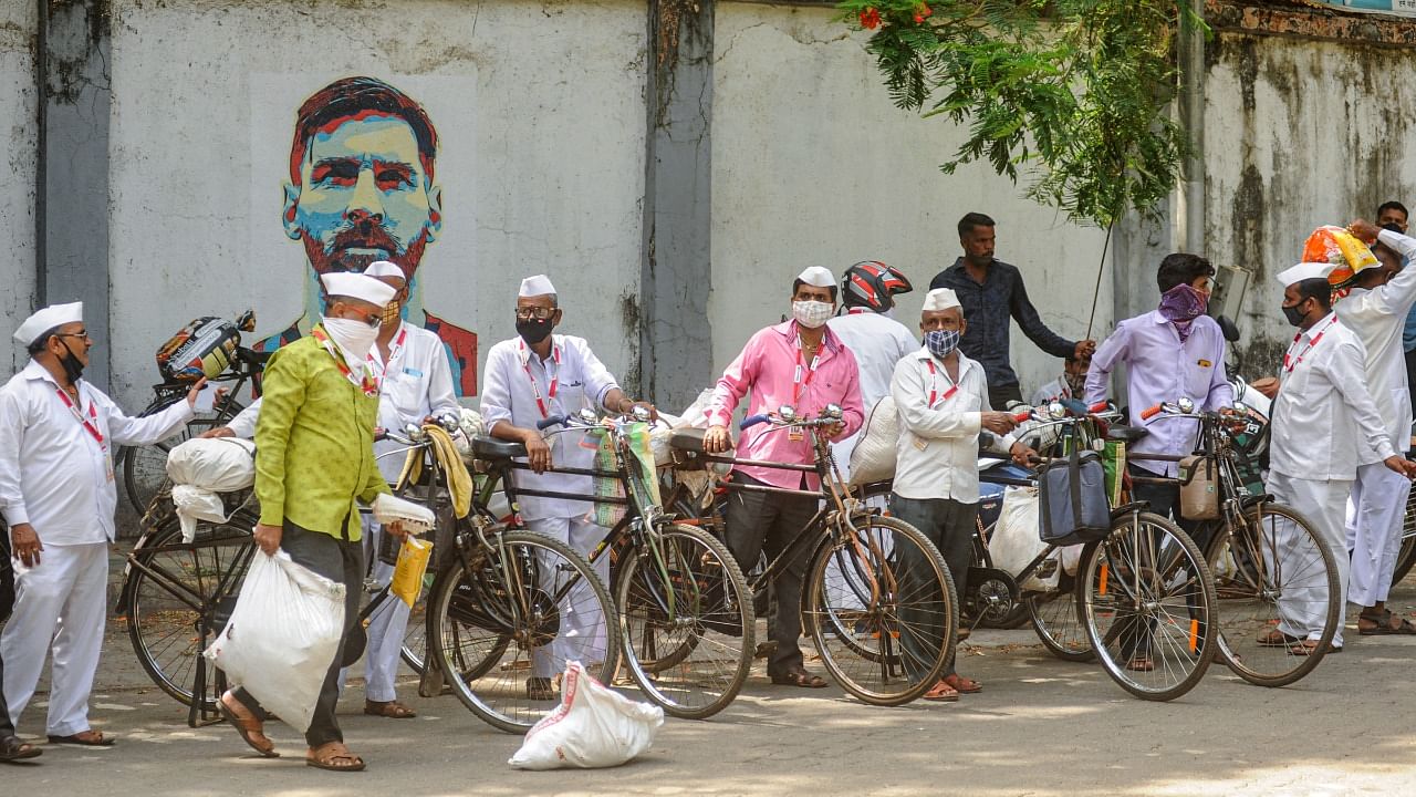 Nutan Mumbai 'dabbawala' prepare to leave for work to distribute food during the Covid-induced lockdown in Mumbai. Credit: PTI file photo