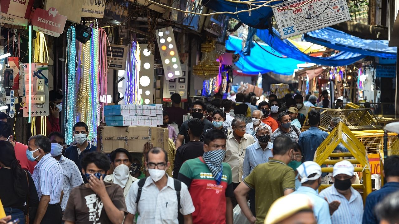 People visit a crowded Chandni Chowk market that reopened after Delhi government eased Covid-induced restrictions, in New Delhi. Credit: PTI Photo