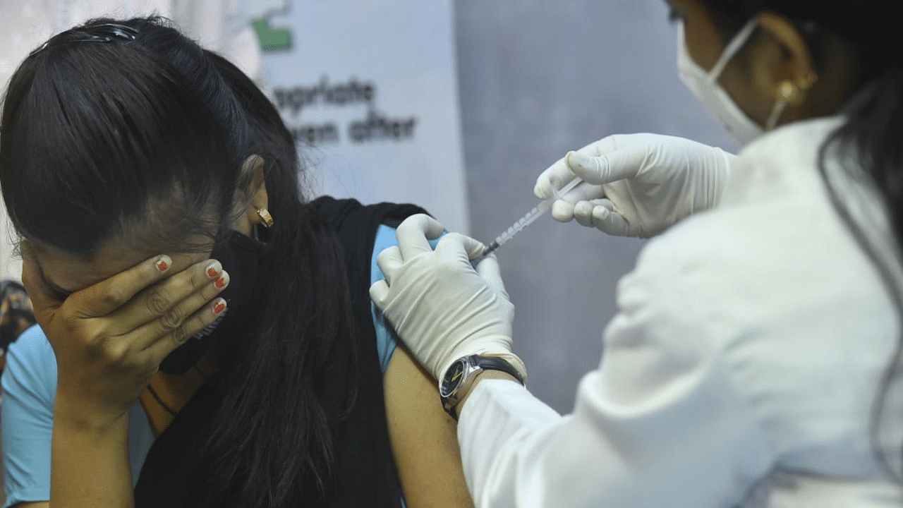 A medic administers a dose of the Covid-19 vaccine to a staff of Parliament House, in New Delhi. Credit: PTI Photo